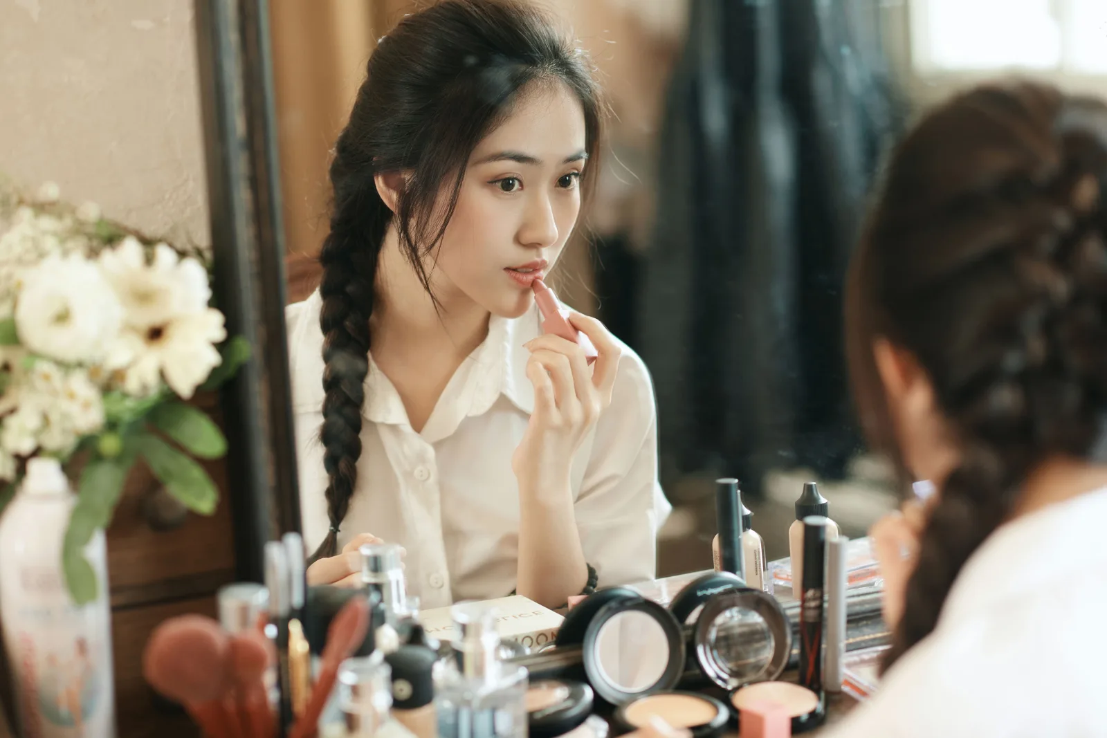 Học viên tự trang điểm và kiểm tra lớp nền trong gương khi thực hành
